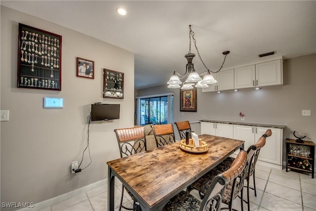 7116 Blanquilla Ct Unit 220, Fort Myers, FL 33908 - dining space with light tile patterned flooring, a chandelier, and baseboards