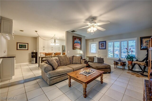 7116 Blanquilla Ct Unit 220, Fort Myers, FL 33908 - living area featuring light tile patterned flooring, a ceiling fan, a chandelier, and baseboards