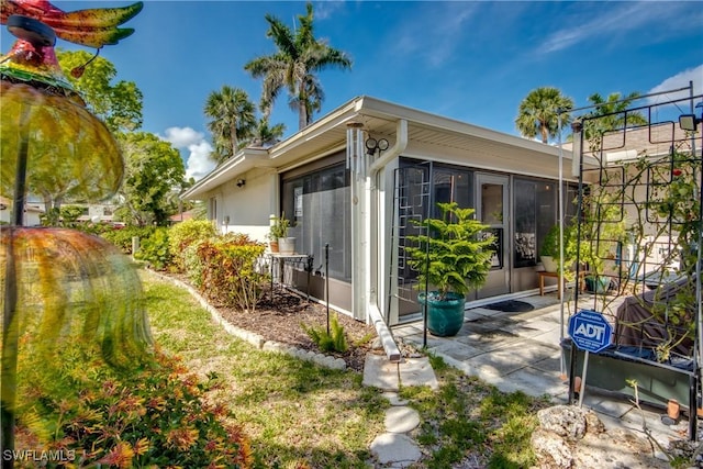 7116 Blanquilla Ct Unit 220, Fort Myers, FL 33908 - view of property exterior with a sunroom and a patio area