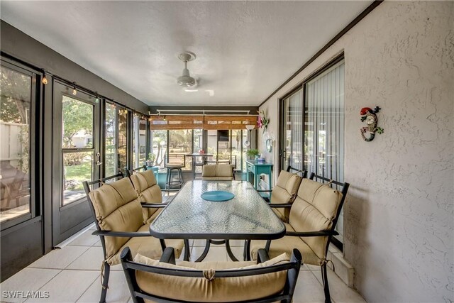 7116 Blanquilla Ct Unit 220, Fort Myers, FL 33908 - sunroom / solarium featuring a textured wall, tile patterned floors, and outdoor dining space