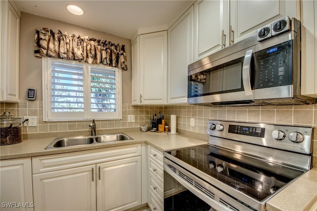 7116 Blanquilla Ct Unit 220, Fort Myers, FL 33908 - kitchen featuring stainless steel appliances, a sink, white cabinetry, light countertops, and recessed lighting