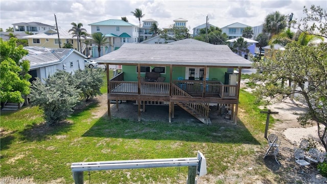 171 Primo Dr, Fort Myers Beach, FL 33931 - rear view of house with a lawn, a residential view, stairs, and a wooden deck