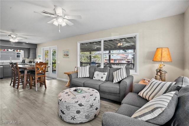 171 Primo Dr, Fort Myers Beach, FL 33931 - living area featuring ceiling fan, light wood finished floors, and baseboards