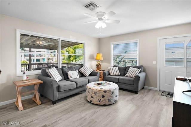 171 Primo Dr, Fort Myers Beach, FL 33931 - living room with a ceiling fan, light wood-type flooring, baseboards, and healthy amount of natural light