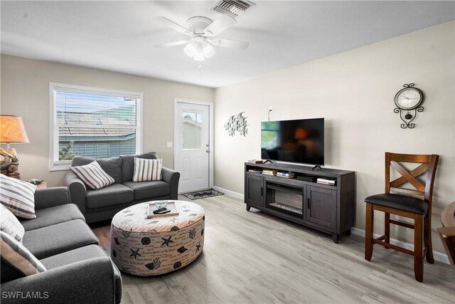171 Primo Dr, Fort Myers Beach, FL 33931 - living area featuring light wood-style floors, ceiling fan, and baseboards