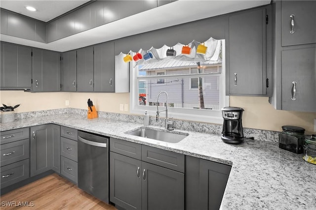 171 Primo Dr, Fort Myers Beach, FL 33931 - kitchen featuring stainless steel dishwasher, a sink, gray cabinetry, light stone countertops, and light wood-style flooring