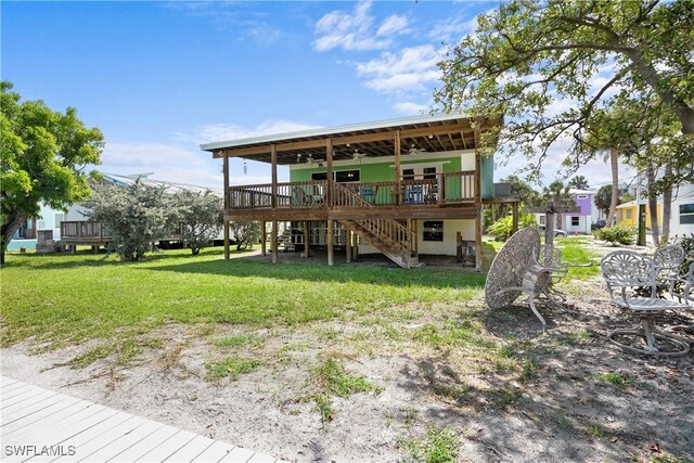 171 Primo Dr, Fort Myers Beach, FL 33931 - rear view of house featuring ceiling fan, a yard, stairway, and a wooden deck