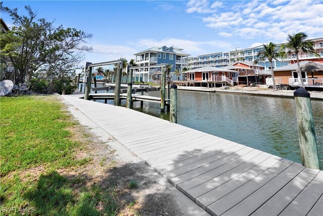 171 Primo Dr, Fort Myers Beach, FL 33931 - dock area featuring a water view, boat lift, and a yard