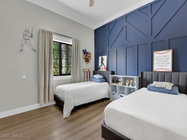 16970 Laurelin Ct, North Fort Myers, FL 33917 - bedroom featuring crown molding, a decorative wall, wood finished floors, ceiling fan, and baseboards