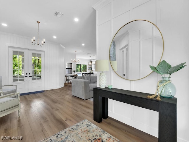 16970 Laurelin Ct, North Fort Myers, FL 33917 - living area with a chandelier, ornamental molding, french doors, wood finished floors, and recessed lighting