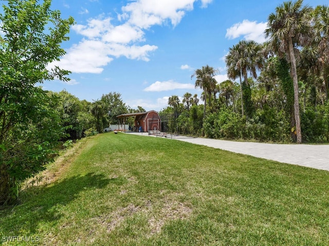 16970 Laurelin Ct, North Fort Myers, FL 33917 - view of green lawn featuring a barn and an outbuilding