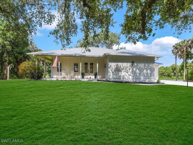 16970 Laurelin Ct, North Fort Myers, FL 33917 - back of property featuring french doors, a yard, and metal roof