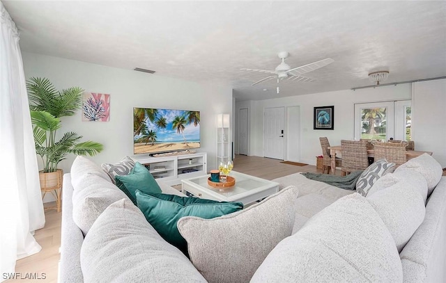 1432 Wellington Ct, Cape Coral, FL 33904 - living room featuring light wood finished floors, a ceiling fan, and french doors