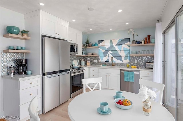 1432 Wellington Ct, Cape Coral, FL 33904 - kitchen featuring open shelves, appliances with stainless steel finishes, backsplash, a sink, and recessed lighting