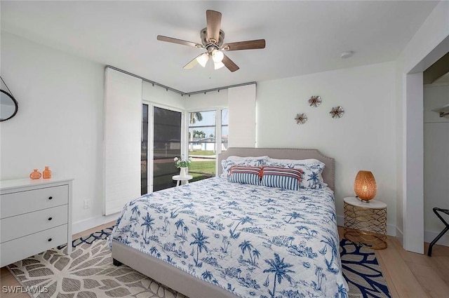 1432 Wellington Ct, Cape Coral, FL 33904 - bedroom with light wood-style floors, a ceiling fan, and baseboards