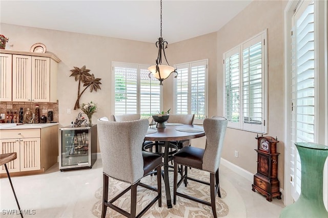3181 Bramble Cove Ct, Fort Myers, FL 33905 - dining area featuring wine cooler and baseboards
