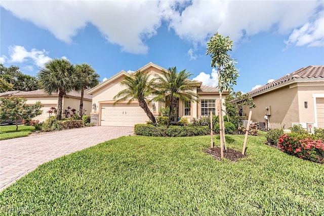 3181 Bramble Cove Ct, Fort Myers, FL 33905 - view of front facade with decorative driveway, a garage, a front lawn, and stucco siding