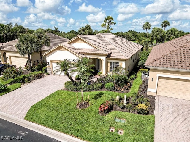 3181 Bramble Cove Ct, Fort Myers, FL 33905 - view of front of property featuring stucco siding, driveway, a front yard, and a tiled roof