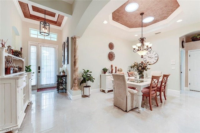 3181 Bramble Cove Ct, Fort Myers, FL 33905 - dining area featuring a tray ceiling, arched walkways, a chandelier, ornamental molding, and a towering ceiling