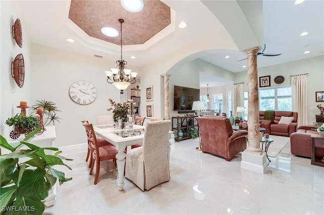 3181 Bramble Cove Ct, Fort Myers, FL 33905 - dining area with decorative columns, arched walkways, recessed lighting, a chandelier, and a tray ceiling