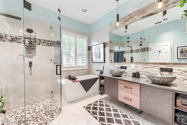 3181 Bramble Cove Ct, Fort Myers, FL 33905 - full bath featuring a freestanding bath, a stall shower, double vanity, backsplash, and tile patterned flooring