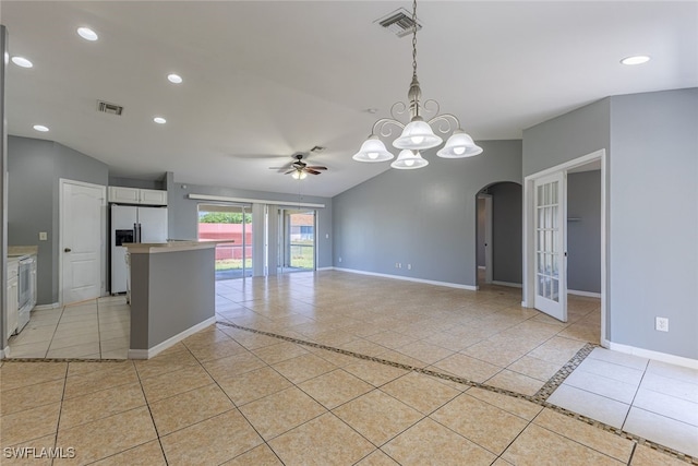 460 Petite Ave, Lehigh Acres, FL 33974 - kitchen featuring light tile patterned floors, stainless steel fridge, arched walkways, baseboards, and recessed lighting