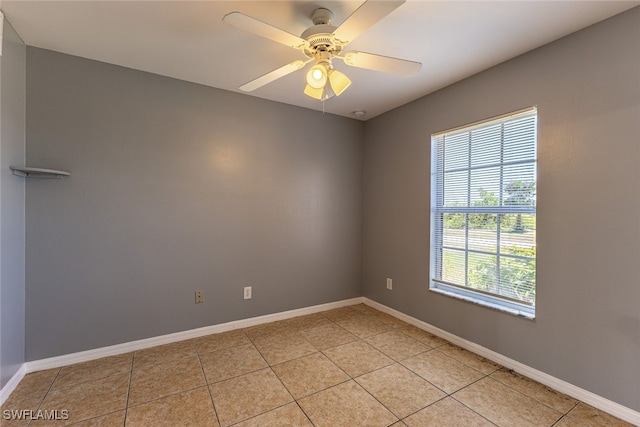 460 Petite Ave, Lehigh Acres, FL 33974 - empty room featuring light tile patterned floors, baseboards, and a ceiling fan