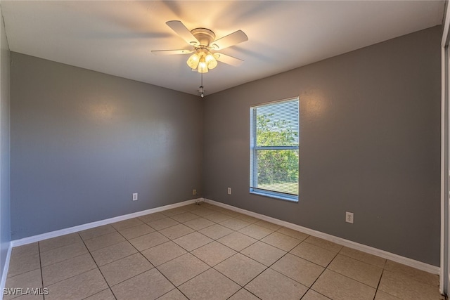 460 Petite Ave, Lehigh Acres, FL 33974 - empty room featuring light tile patterned floors, a ceiling fan, and baseboards