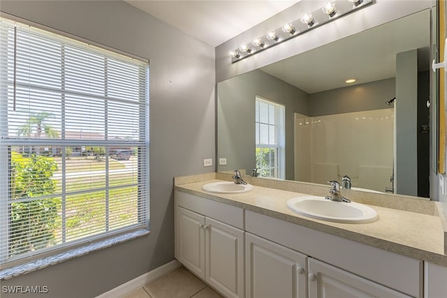 460 Petite Ave, Lehigh Acres, FL 33974 - bathroom featuring double vanity, plenty of natural light, tile patterned flooring, and a shower