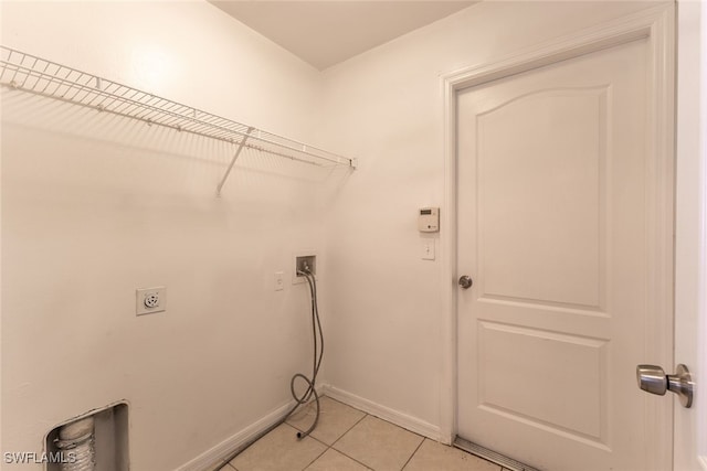 460 Petite Ave, Lehigh Acres, FL 33974 - laundry room featuring electric dryer hookup, washer hookup, light tile patterned floors, and baseboards