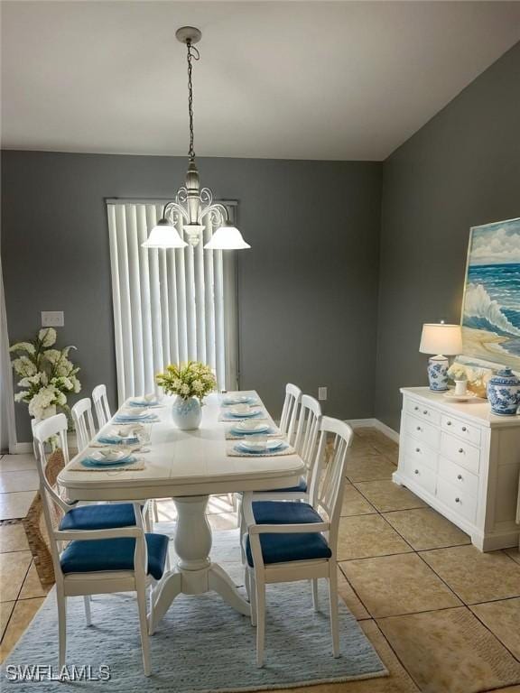 460 Petite Ave, Lehigh Acres, FL 33974 - dining room featuring a chandelier, light tile patterned flooring, healthy amount of natural light, and baseboards