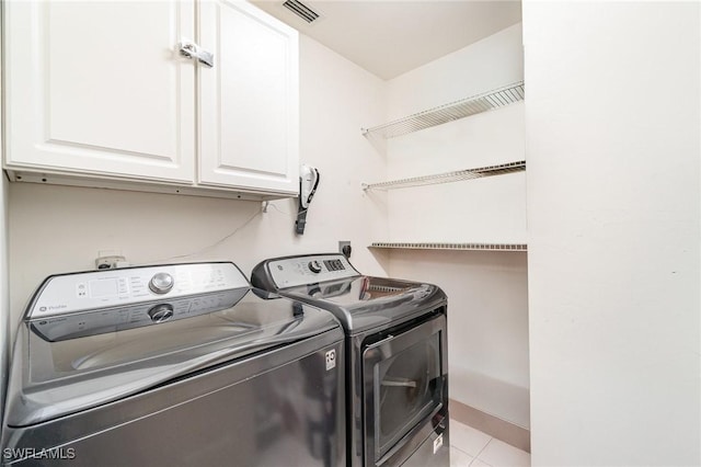 4005 Palm Tree Blvd Unit 103, Cape Coral, FL 33904 - laundry room featuring cabinet space, independent washer and dryer, and tile patterned floors