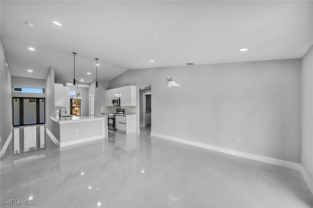 814 Edward Ave, Lehigh Acres, FL 33936 - unfurnished living room with baseboards, vaulted ceiling, a sink, and recessed lighting