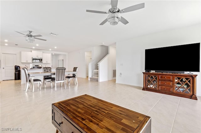 4005 Cavassa Ct, North Fort Myers, FL 33917 - living room with a ceiling fan, stairs, light tile patterned floors, and recessed lighting