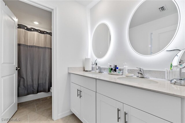 4005 Cavassa Ct, North Fort Myers, FL 33917 - full bathroom with double vanity, toilet, tile patterned flooring, baseboards, and curtained shower