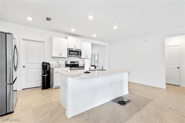 4005 Cavassa Ct, North Fort Myers, FL 33917 - kitchen with stainless steel appliances, light countertops, an island with sink, white cabinets, and recessed lighting