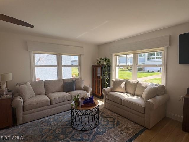 3358 N Key Dr Unit 2, North Fort Myers, FL 33903 - living area with plenty of natural light, wood finished floors, a ceiling fan, and baseboards