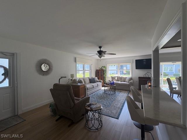 3358 N Key Dr Unit 2, North Fort Myers, FL 33903 - living area featuring a ceiling fan, wood finished floors, and baseboards