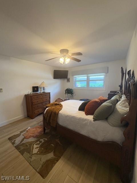 3358 N Key Dr Unit 2, North Fort Myers, FL 33903 - bedroom featuring light wood-type flooring, a ceiling fan, and baseboards