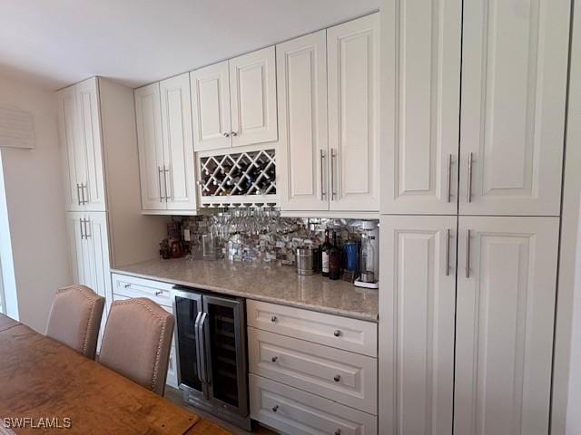 3358 N Key Dr Unit 2, North Fort Myers, FL 33903 - indoor dry bar featuring wine cooler and backsplash