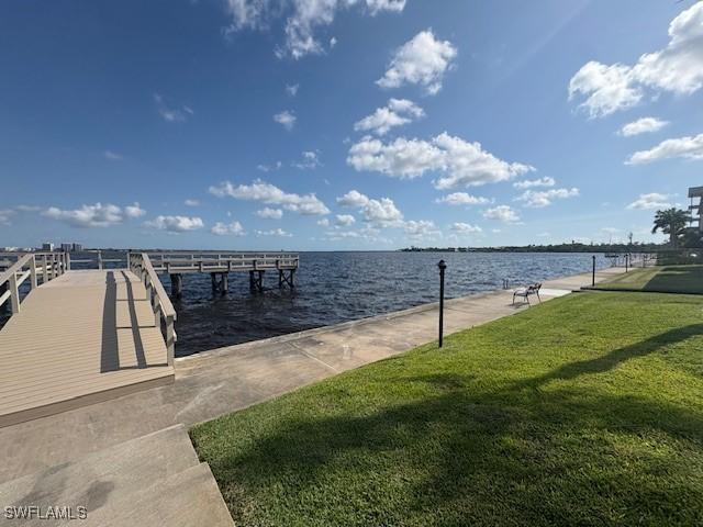 3358 N Key Dr Unit 2, North Fort Myers, FL 33903 - dock area with a lawn and a water view