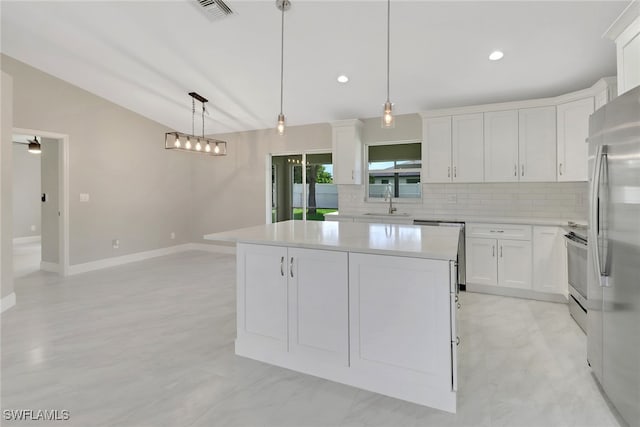 1118 SW 41st Ter, Cape Coral, FL 33914 - kitchen with tasteful backsplash, a center island, light countertops, dishwashing machine, and white cabinetry