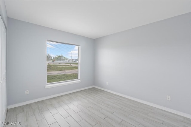 2208/2210 Haviland Ave S, Lehigh Acres, FL 33973 - spare room featuring baseboards and light wood-type flooring