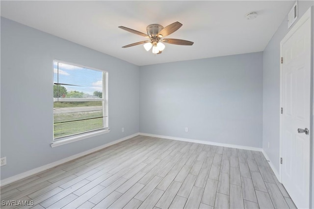 2208/2210 Haviland Ave S, Lehigh Acres, FL 33973 - spare room featuring ceiling fan, light wood-style floors, baseboards, and a smoke detector
