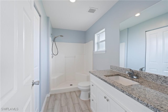 2208/2210 Haviland Ave S, Lehigh Acres, FL 33973 - bathroom featuring a shower, vanity, toilet, recessed lighting, and wood finished floors