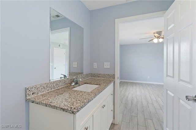 2208/2210 Haviland Ave S, Lehigh Acres, FL 33973 - bathroom featuring a ceiling fan, vanity, wood finished floors, and baseboards