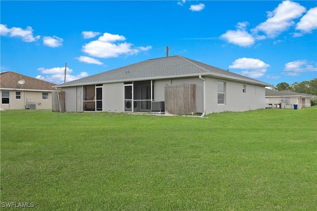 2208/2210 Haviland Ave S, Lehigh Acres, FL 33973 - back of property with a yard, stucco siding, a sunroom, and central AC