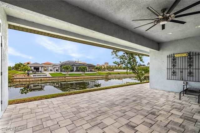 2228 SW 15th Ave, Cape Coral, FL 33991 - view of patio featuring a water view, a ceiling fan, and a residential view