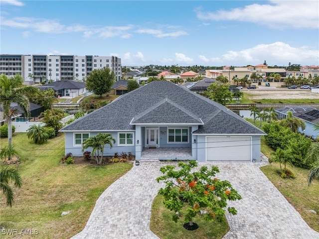 2228 SW 15th Ave, Cape Coral, FL 33991 - ranch-style house with a shingled roof, an attached garage, a front yard, and decorative driveway
