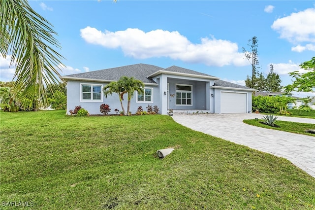 2228 SW 15th Ave, Cape Coral, FL 33991 - view of front facade with an attached garage, decorative driveway, a front lawn, and stucco siding